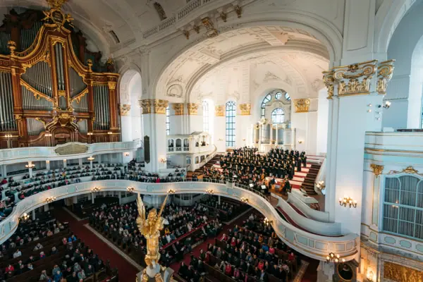 A group of people in a large white building.