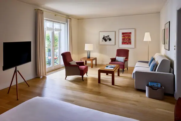 Studio Louis C. Jacob Hotel Hamburg A hotelroom with couches, and elegant interior design.