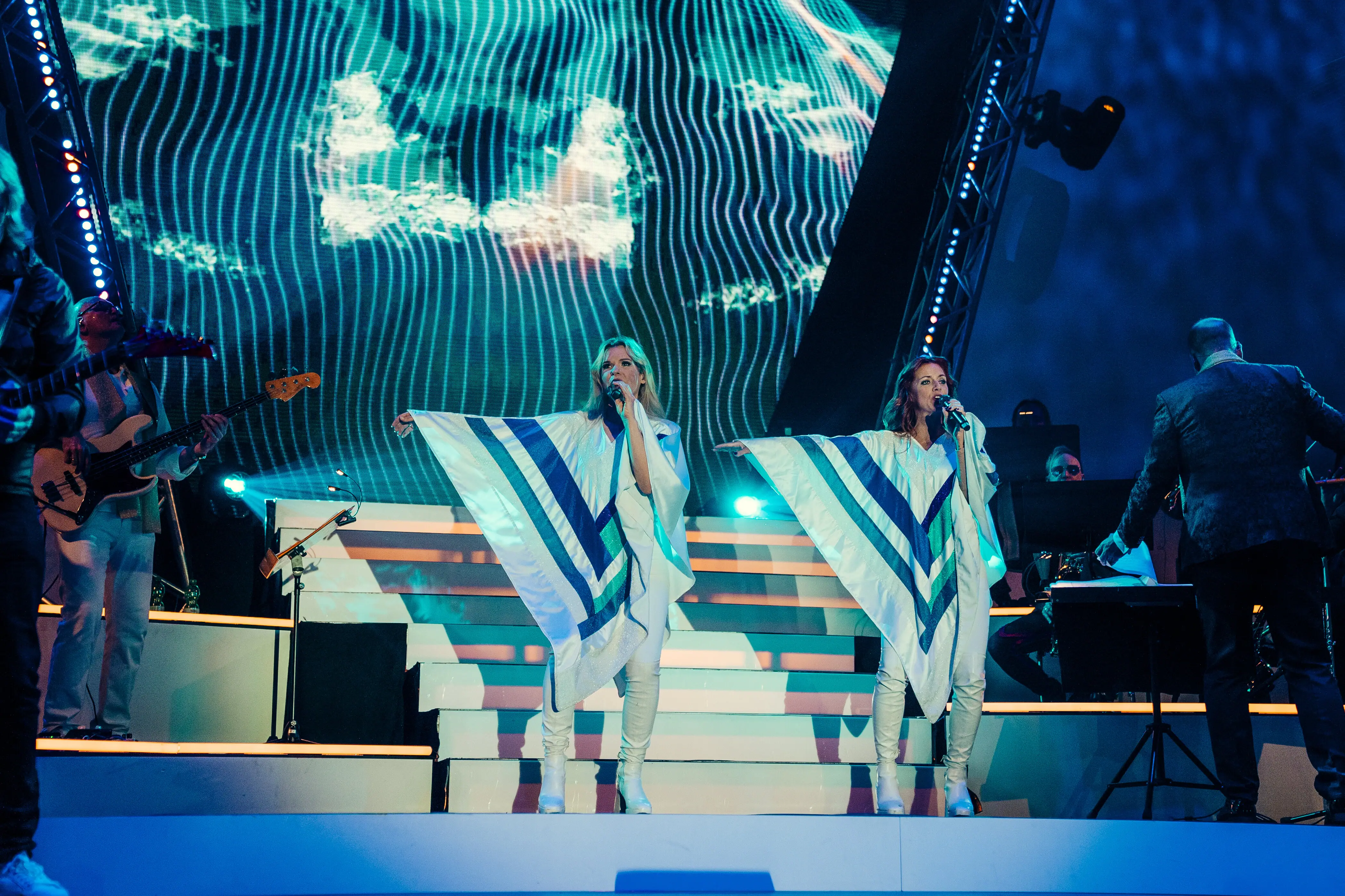 A group of women singing on stage at a concert.