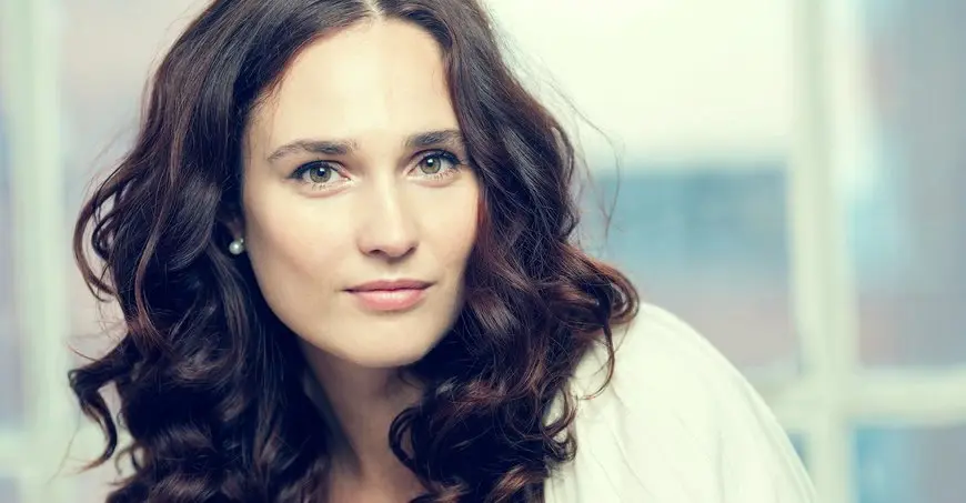 Portrait of a woman with long brown hair.