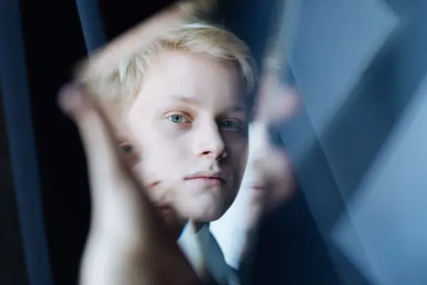 Pianist Alexander Malofeev A boy is looking intently at something.