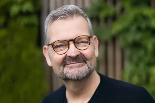 Head Chef Thomas Martin A man wearing glasses and a black shirt.