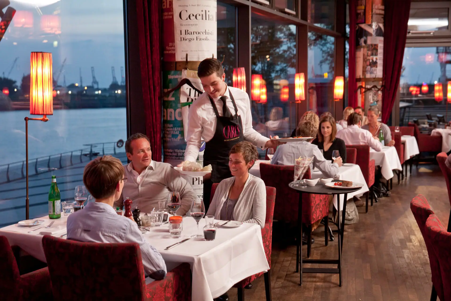 CARLS Restaurant Hamburg Gäste sitzen in der CARLS Brasserie mit Blick auf die Elbe.