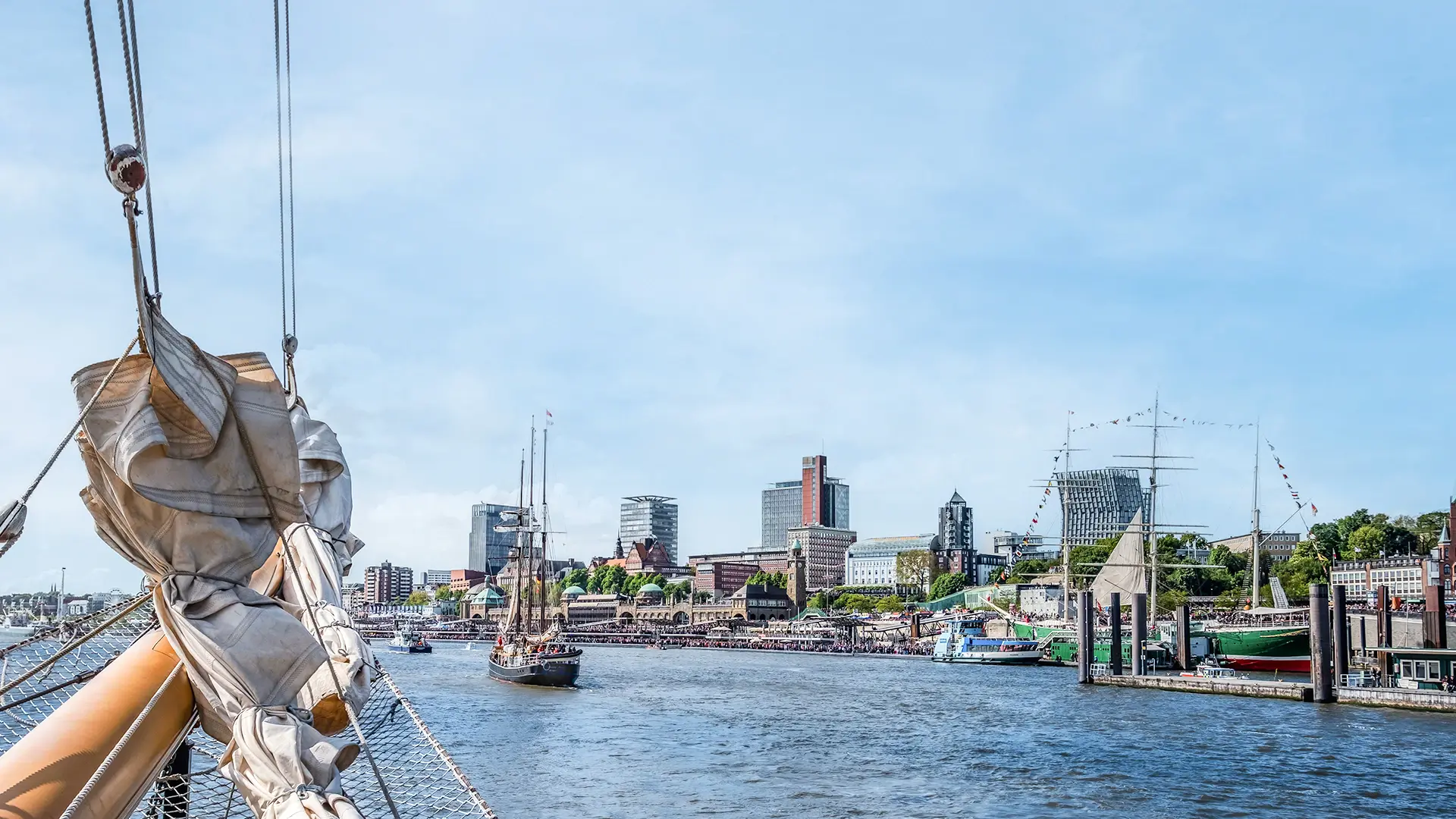 A view of the Elbe and Hamburg harbor from the bow of a ship in bright sunshine. 