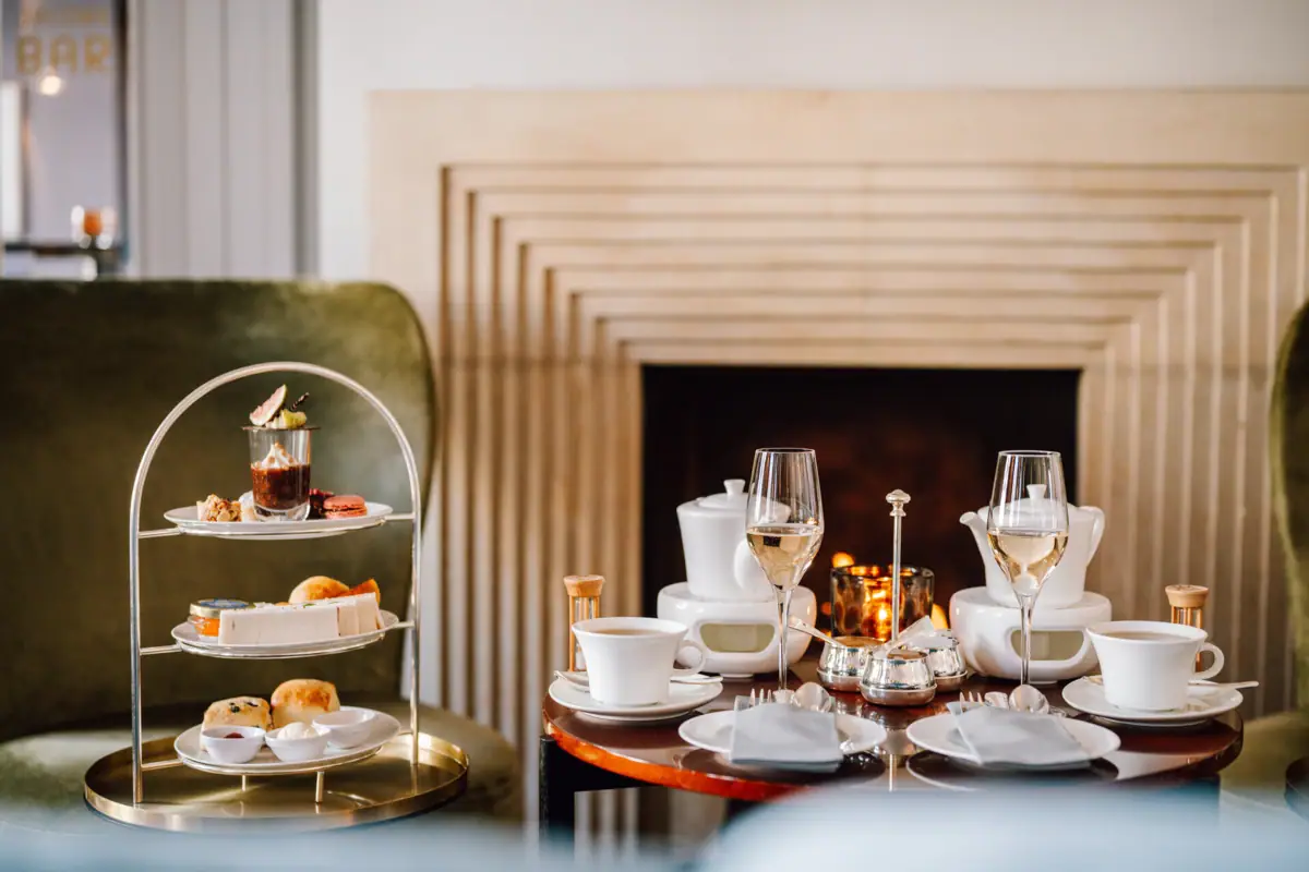 Afternoon Tea A table set with porcelain tableware and serveware, featuring a variety of dishes.