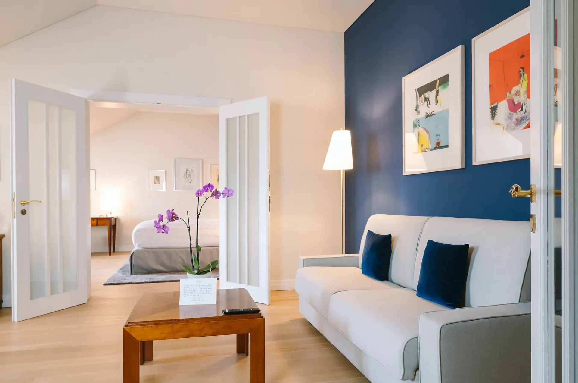Suite Louis C. Jacob Hotel A room with a couch and a table, featuring indoor furniture and interior design elements.