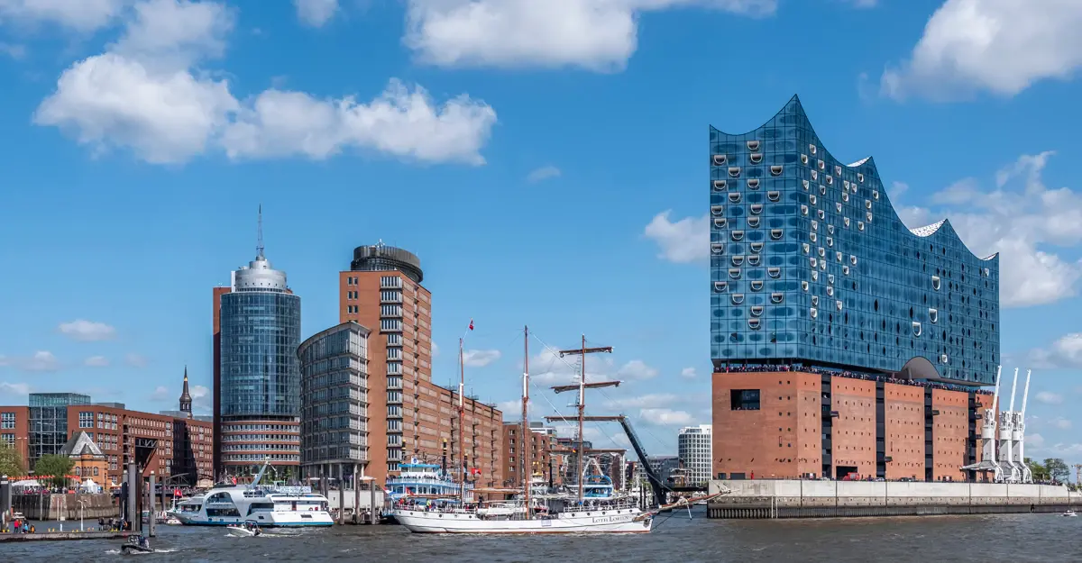 View of the Elbphilharmonie and the surrounding harbor on a sunny day.