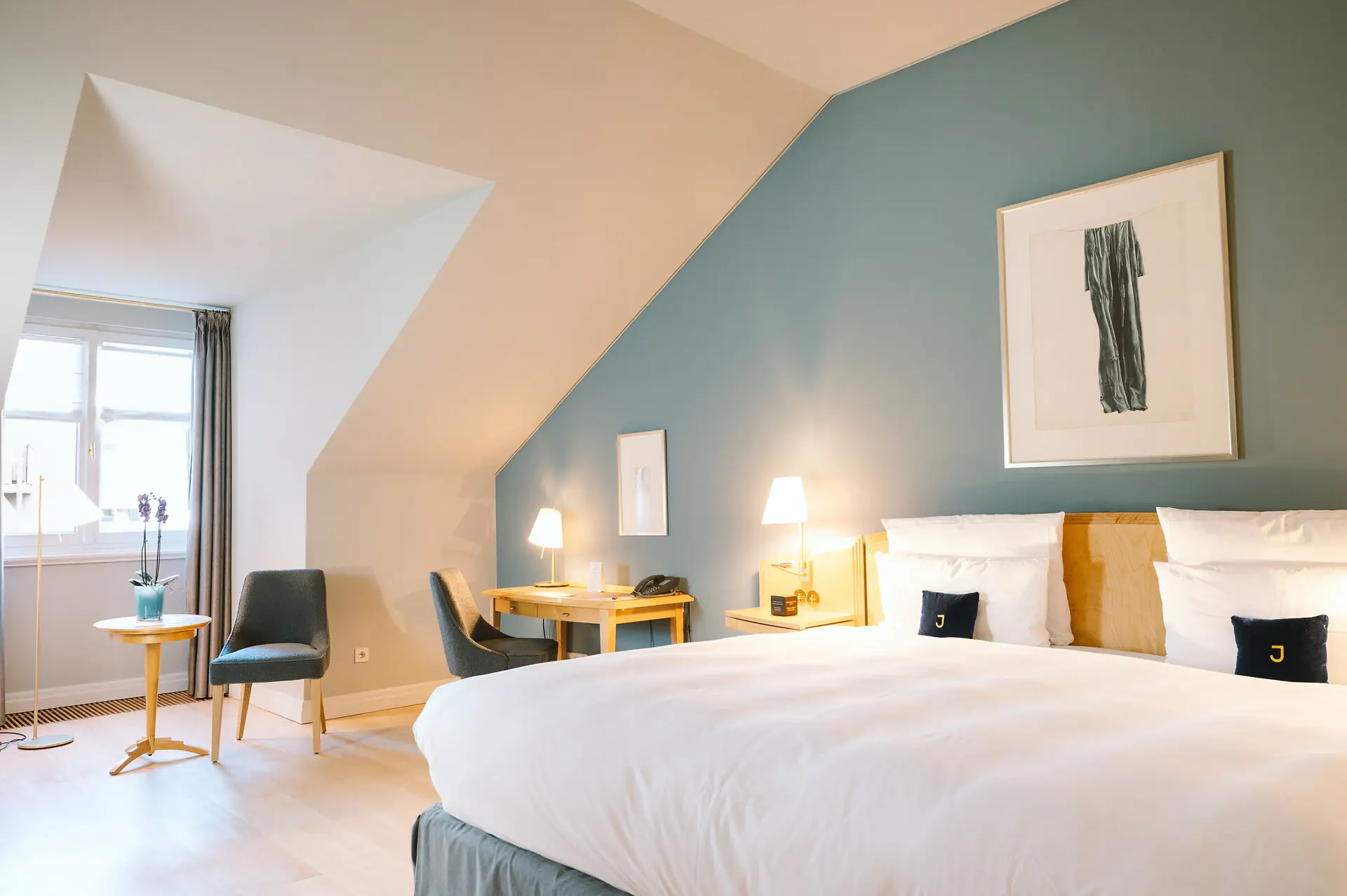 Double room Louis C. Jacob Hotel Hamburg Bedroom with a neatly made bed, a chair, and elegant interior design elements.