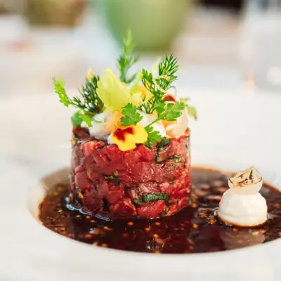 Jacobs Tatar Close-up of a beautifully garnished dish on a plate.