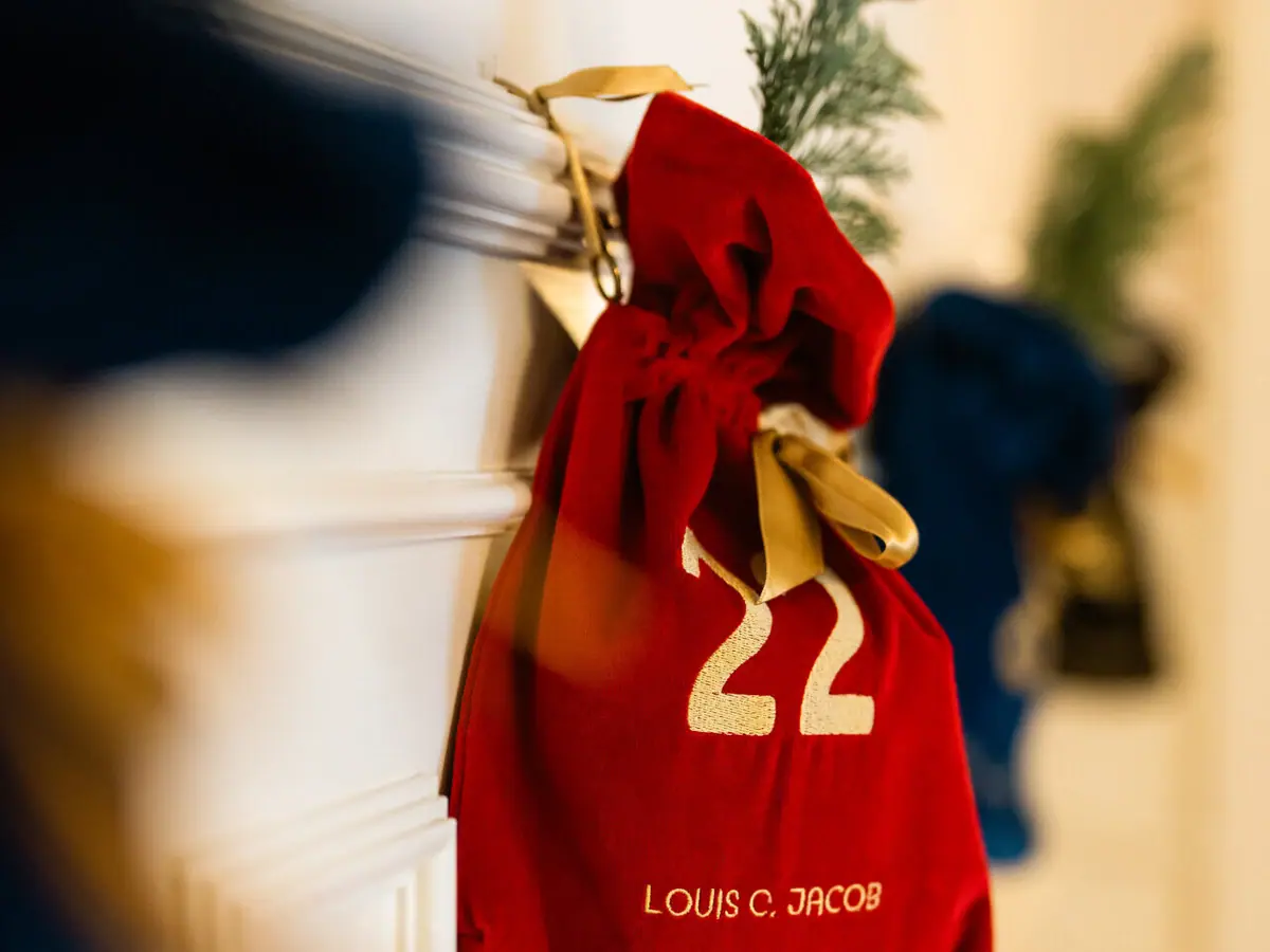 A red bag with gold lettering on a white door