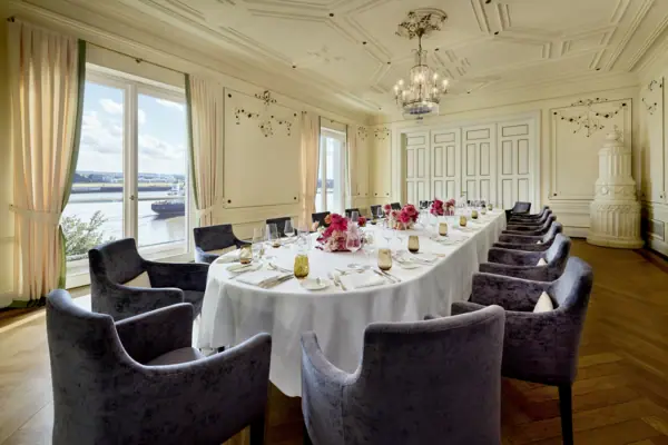 French Room An event room at the Louis C. Jacob, featuring a long table decorated with flowers.