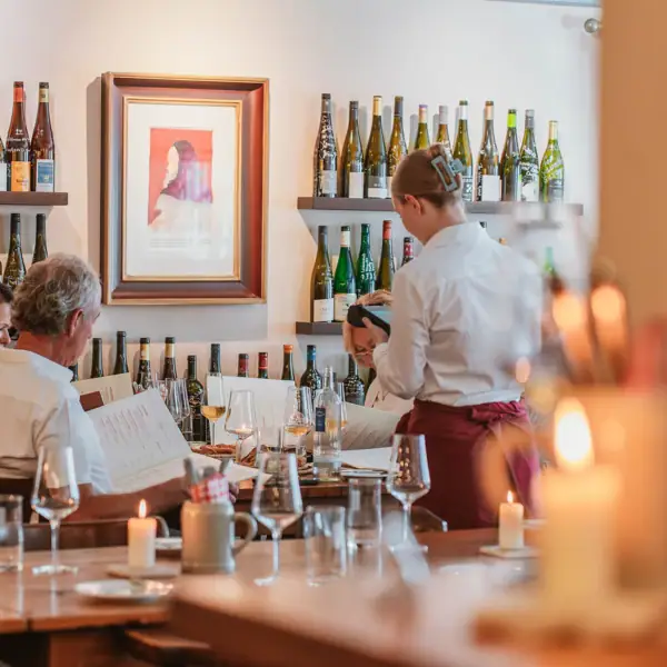 A group of people enjoying drinks at a restaurant.